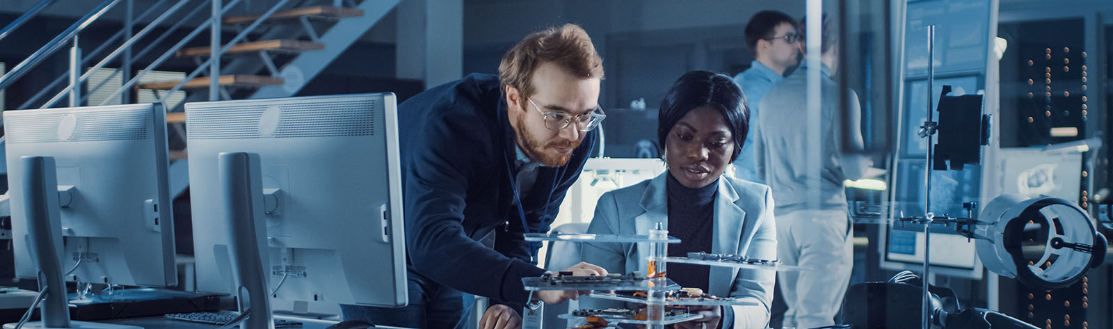 two engineers consulting about a PCB choice