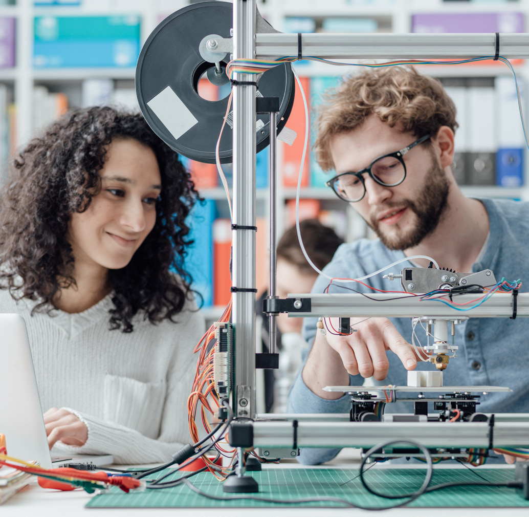 Man and Woman Working on Electronics