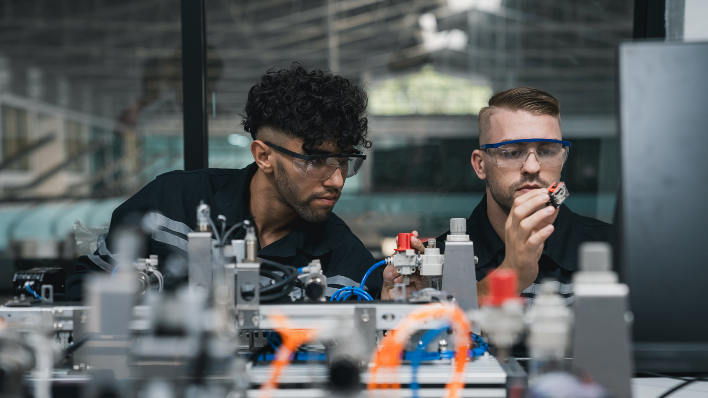 Two Men Working on Electronics